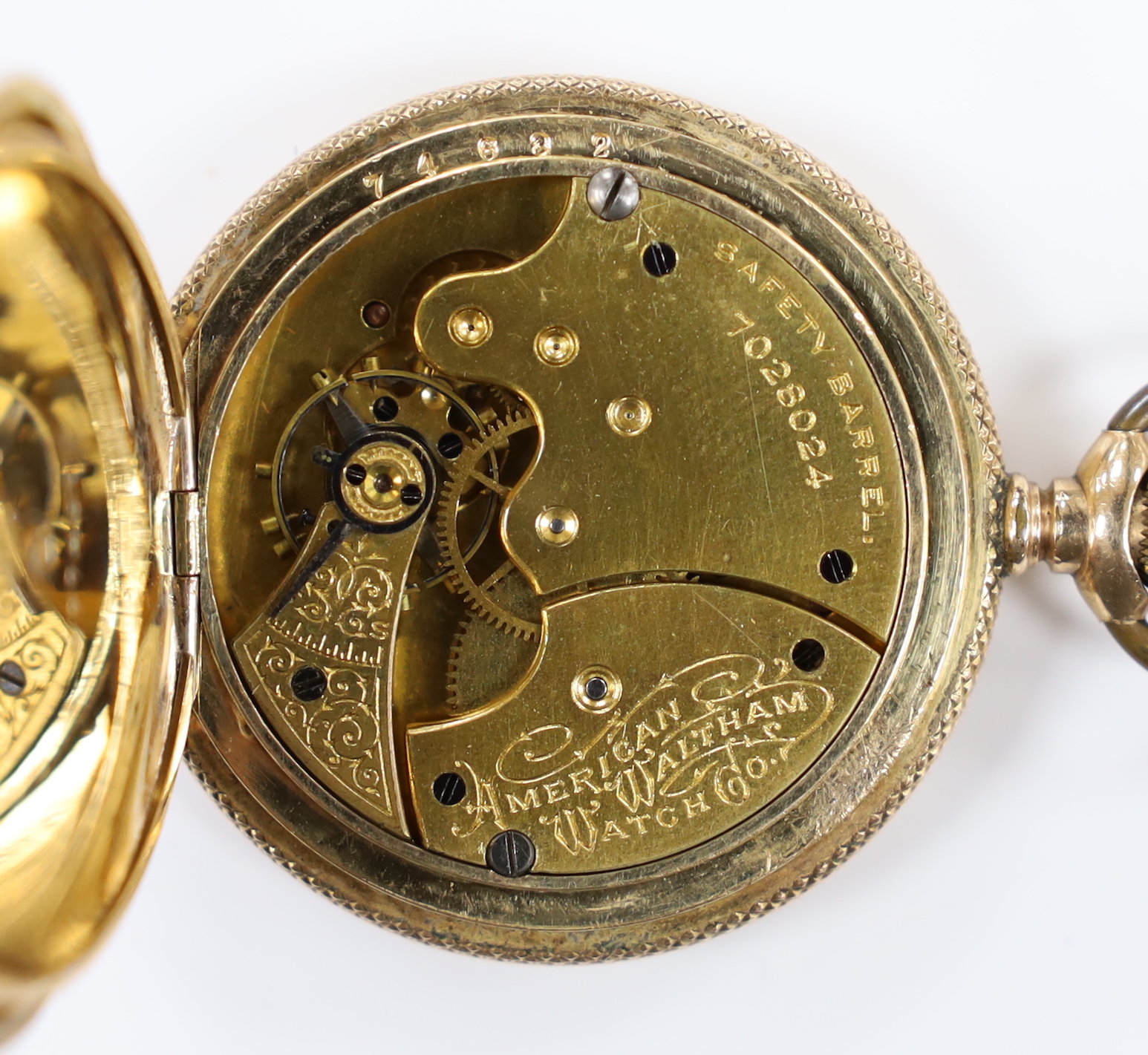 An American Waltham engraved gold plated hunter pocket watch, case diameter 42mm, together with a 9ct double strand chain, 39cm, chain 29.6 grams.